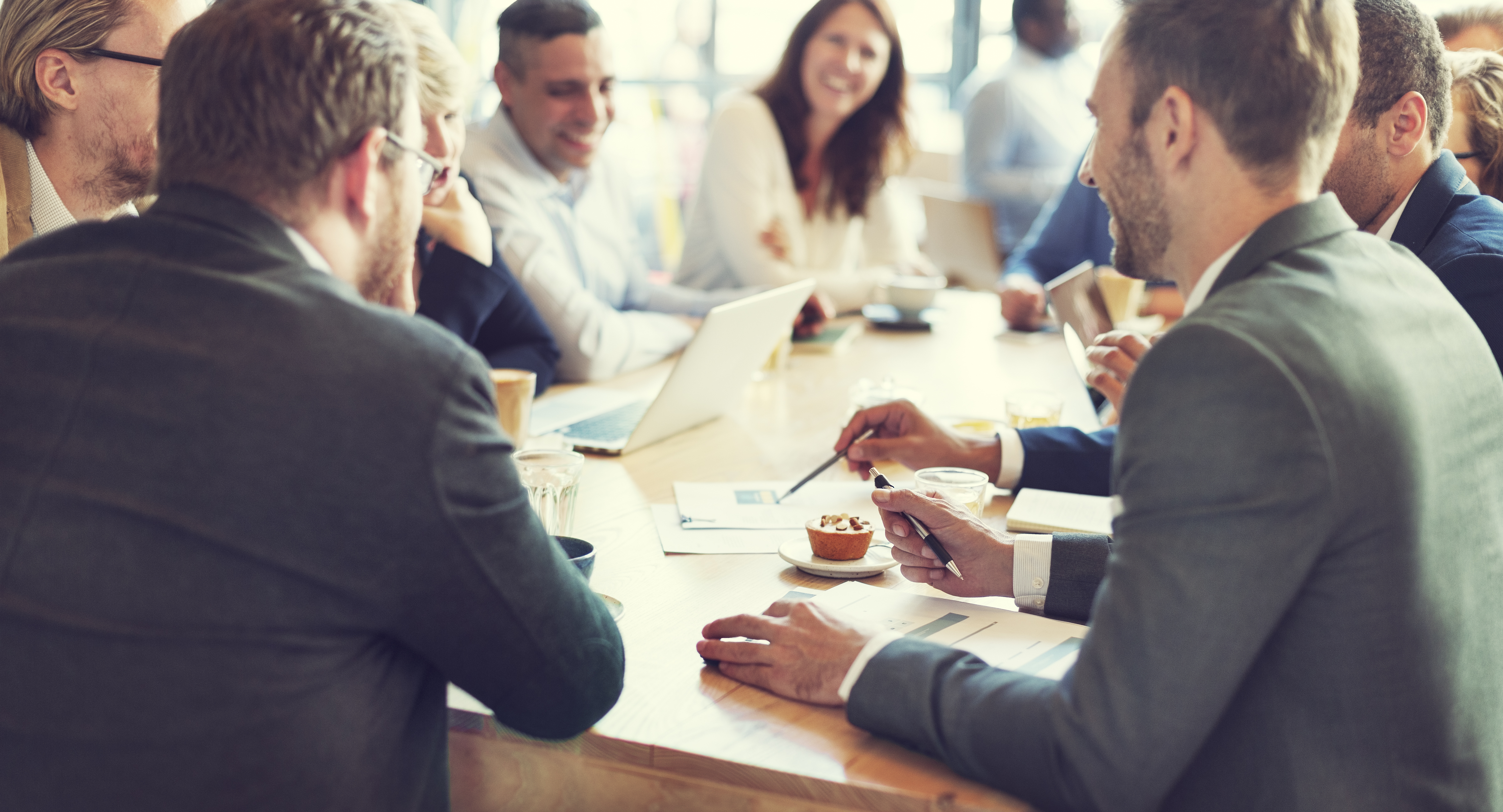 A group of business people meeting around a table having an animated discussion