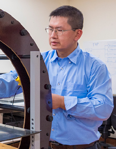 Man performing maintenance on a helmholtz coil
