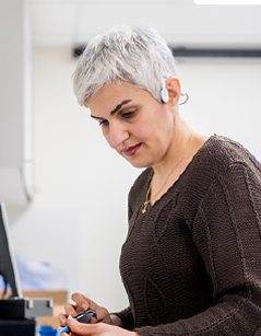 Woman deep in concentrating using hands to perform work at a workstation