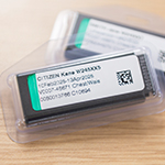 Two PRMS OSL monitors laid on each other on a wooden surface