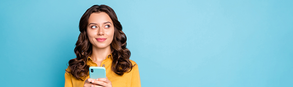 Close up of woman thinking, looking to the side, phone in hand