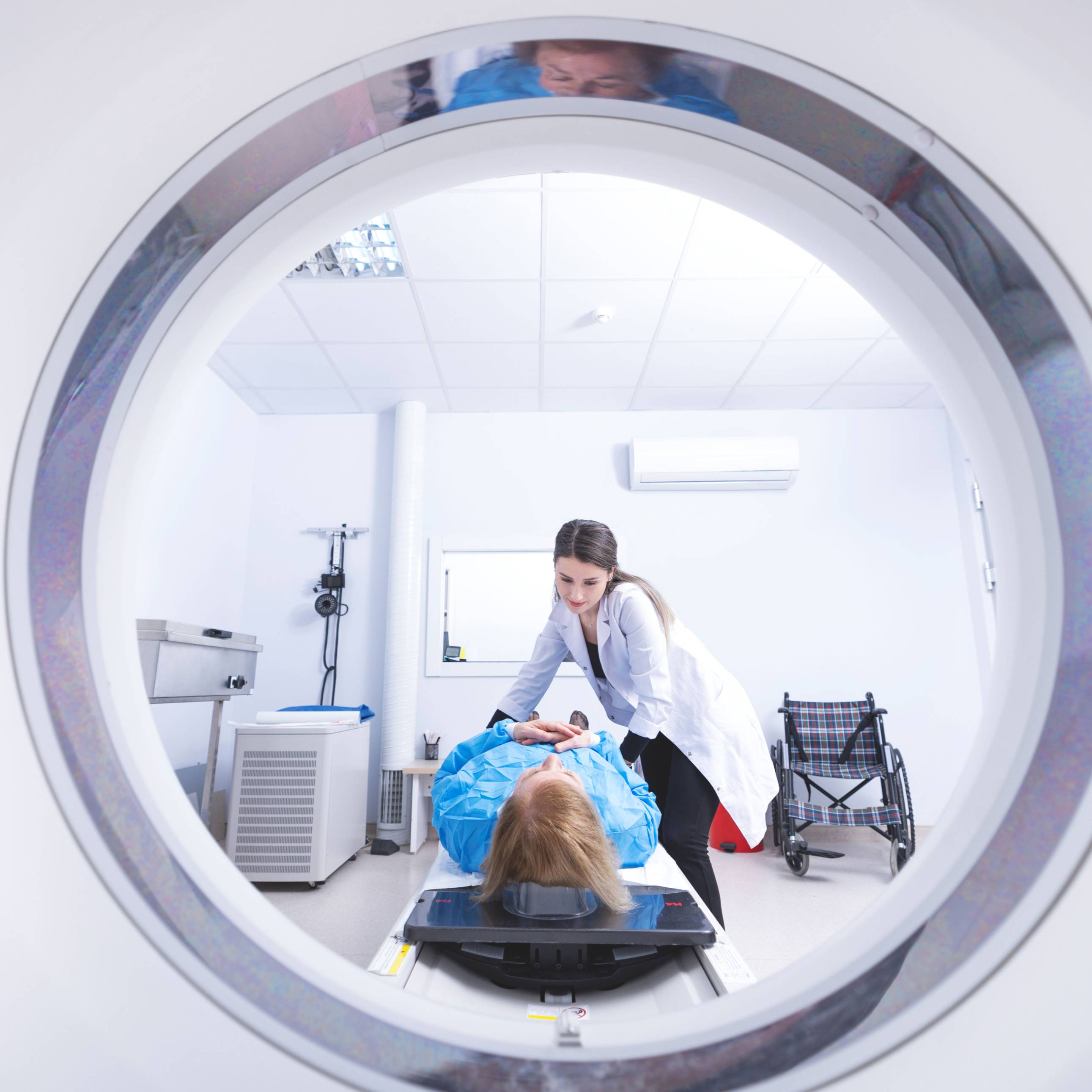 Cancer treatment in a modern medical private clinic or hospital with a linear accelerator. Professional doctors team working while the woman is undergoing radiation therapy for cancer