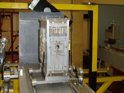 LEFAC with cover removed, revealing the guard electrodes and the gap which allows the beam to pass out of the chamber. The X-ray source is behind the Pb sheet in front of the chamber.