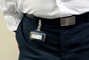 OSL monitor clipped to the belt on pants.