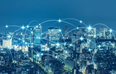 Landscape photo of city at night with overlaid lights showing connections