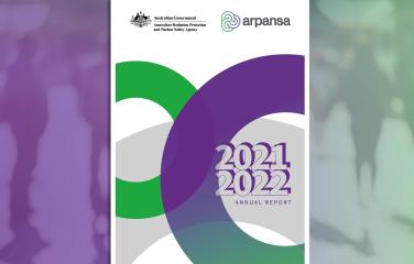 Image of Annual Report 2021-22 cover on top of blurred image of people standing