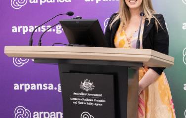 A/Prof Sarah Loughran is at an ARPANSA lectern