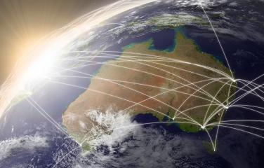 A view of Australia and surrounding water from space with white lines bounding off Australia into other directions.
