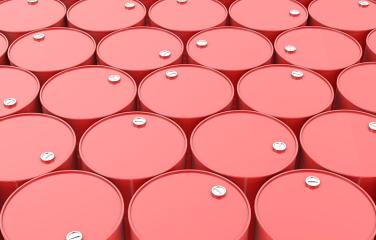 Large group of red drums stacked tightly next to one another.