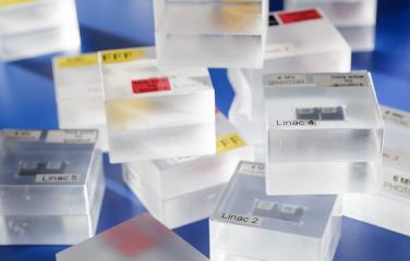 A haphazard pile of plastic containers designed to hold dosimeters used to calibrate radiotherapy equipment.