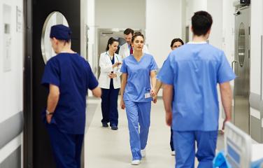 Long shot of medical personnel in a hospital coridoor