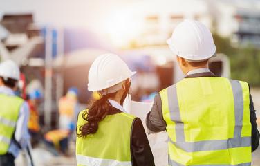 Man and woman working at an outdoor construction site