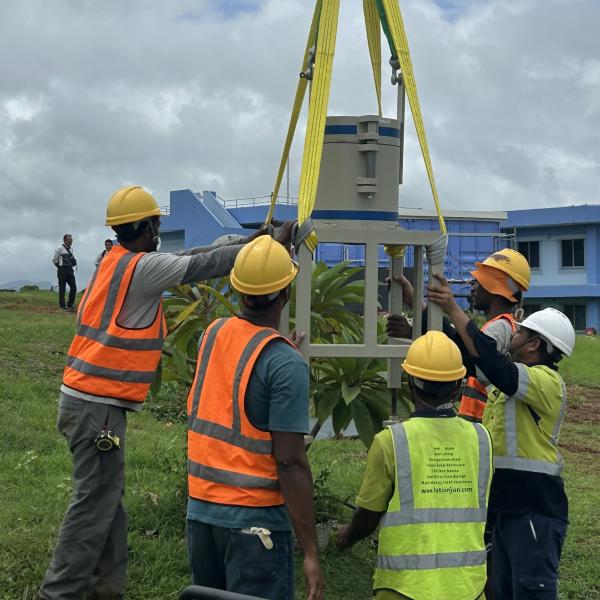 A group of people are installing equipment in Fiji for a new radiation monitoring station