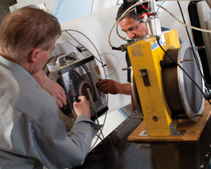 ARPANSA staff prepare a monitor chamber (left) used to confirm the linac output before measurements with the primary standard graphite calorimeter (right)