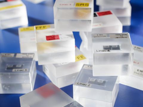 A haphazard pile of plastic containers designed to hold dosimeters used to calibrate radiotherapy equipment.